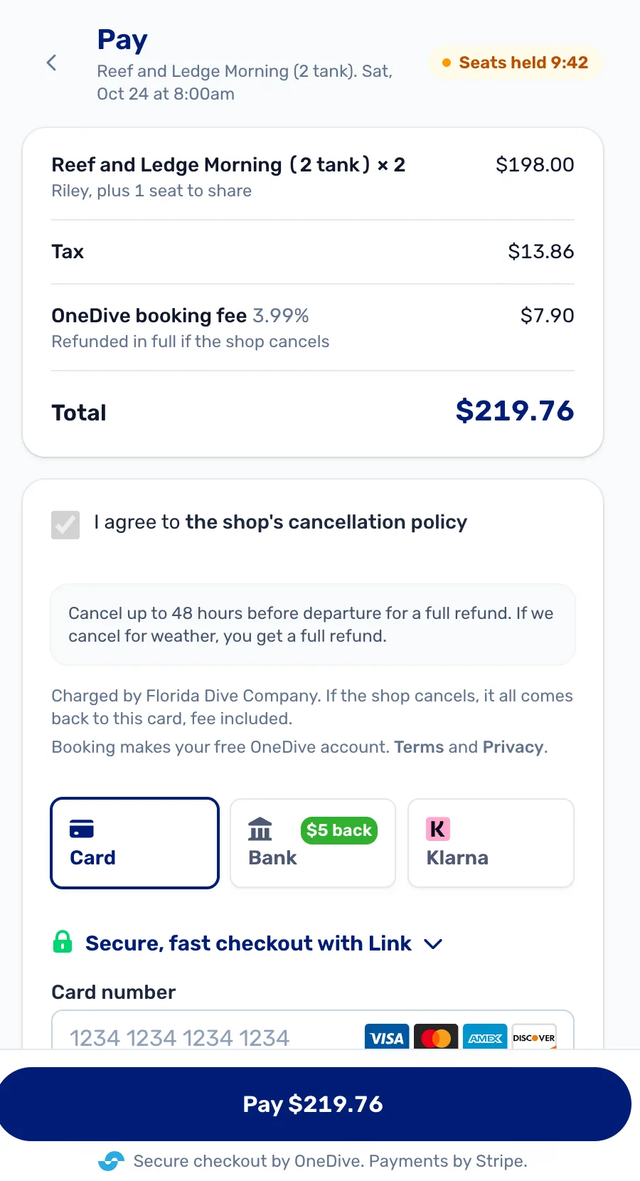 Pay: 2 seats $198.00, tax $13.86, OneDive booking fee 3.99% $7.90, total $219.76, the cancellation policy ticked, Seats held 9:42, and Card, Bank or Klarna