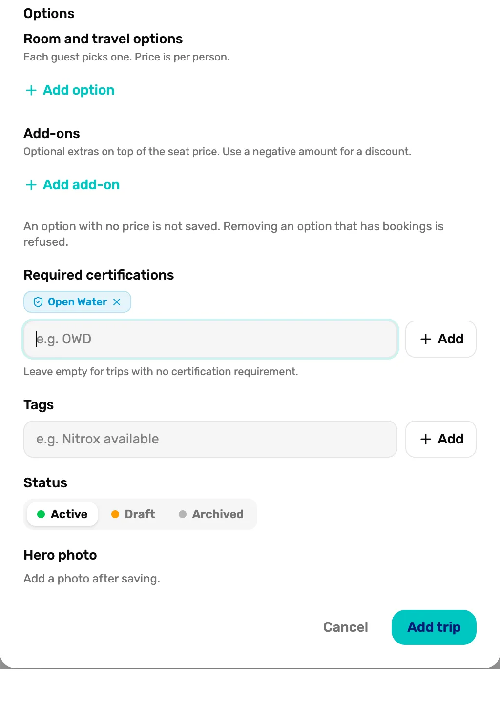 The bottom of the Add trip window: Room and travel options with Add option, Add-ons with Add add-on, Required certifications with Open Water added, Tags, Status set to Active, Hero photo, and the Add trip button
